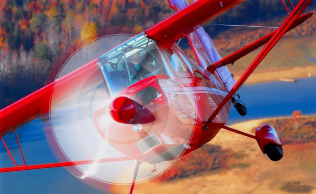 red airplane flying for an aircraft appraisal